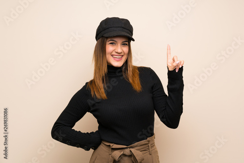 Fashion woman with hat showing and lifting a finger in sign of the best © luismolinero
