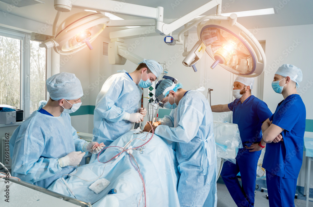 Spinal surgery. Group of surgeons in operating room with surgery equipment. Laminectomy Spinal surgery. Group of surgeons in operating room with surgery equipment. Laminectomy