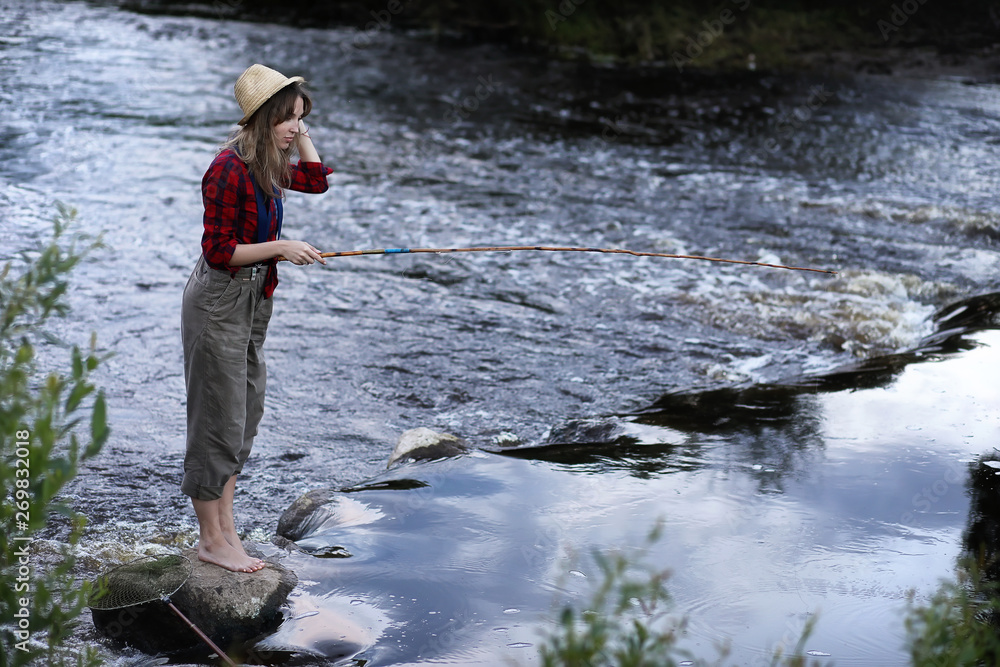 Girl by the river with a fishing rod Girl by the river with a fishing rod
