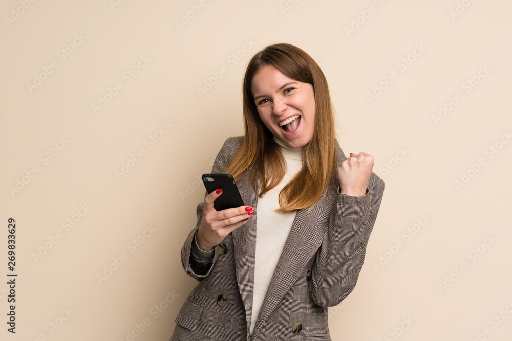Young business woman with phone in victory position Young business woman with phone in victory position
