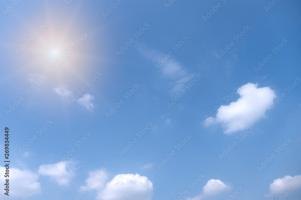 Beautiful white clouds with sun on blue sky.Color shade gradient from white to blue for background wallpaper.