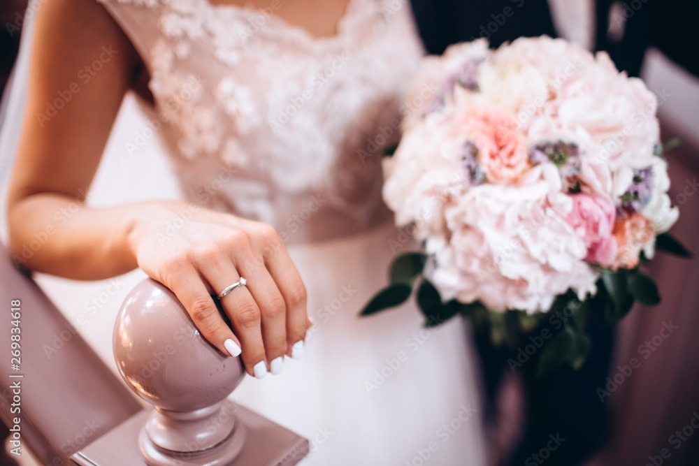 the bride is holding a wedding bouquet. delicate wedding bouquet in white and lilac tones. the bride is holding a wedding bouquet. delicate wedding bouquet in white and lilac tones.