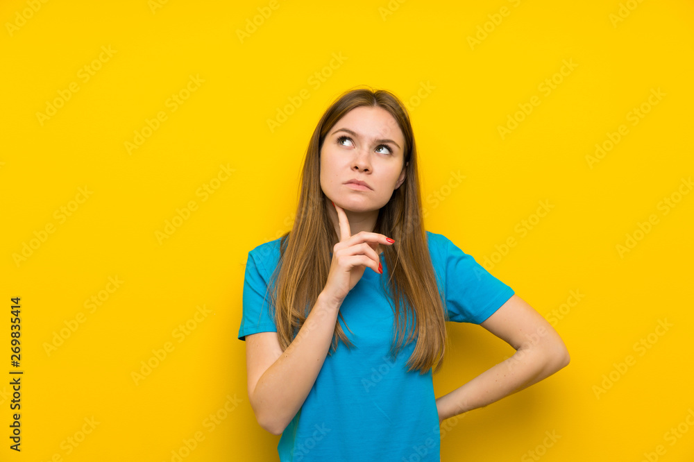 Young woman with blue shirt thinking an idea