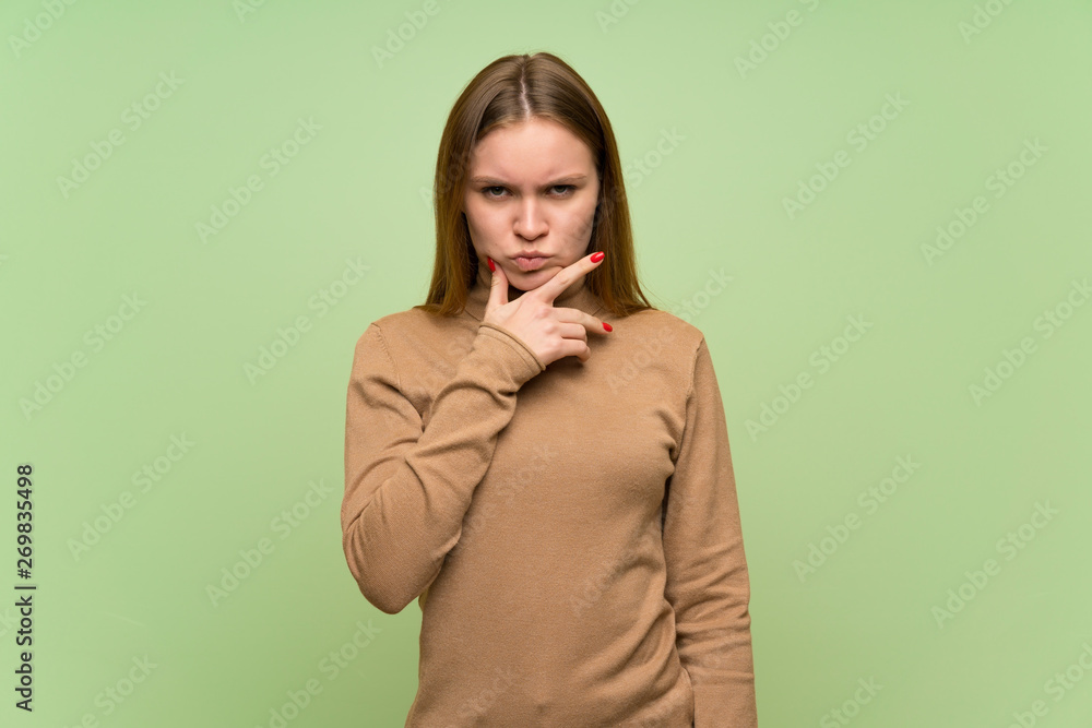 Young woman with turtleneck sweater thinking Young woman with turtleneck sweater thinking