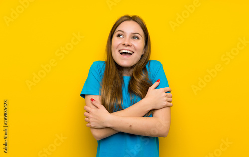 Young woman with blue shirt hugging