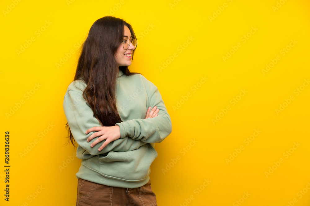 Teenager girl with sweatshirt standing and looking to the side Teenager girl with sweatshirt standing and looking to the side