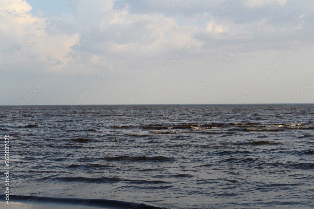 White lake with waves and blue sky in spring White lake with waves and blue sky in spring