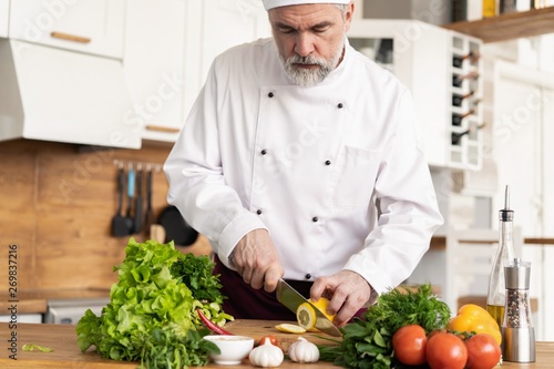 Chef cutting fresh and delicious vegetables for cooking.