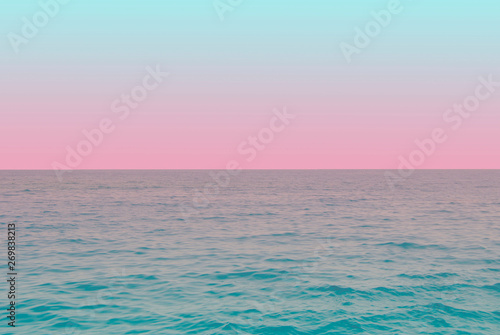 tender view of green water and blue pink gradient sky