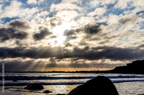 Sun starts to set over the beach, Opunake Beach, Taranaki, New Zealand photo