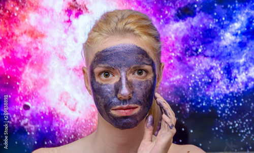 Fototapeta Naklejka Na Ścianę i Meble -  Blonde model wearing a galaxy, sparkle peel off  mask