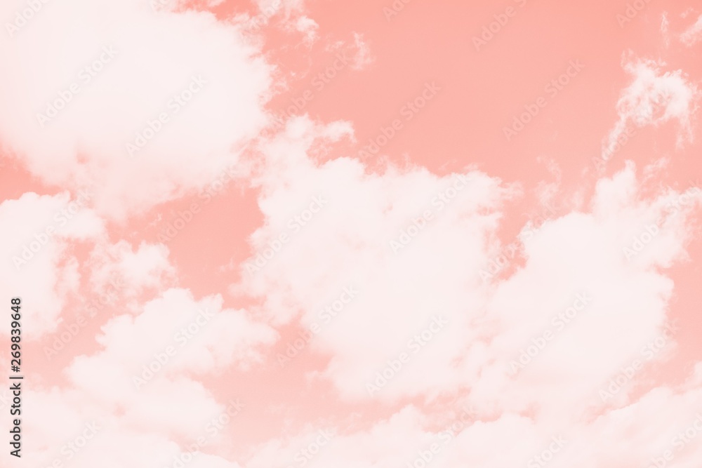 Pink coral color sky background with white clouds. Coral gradient background