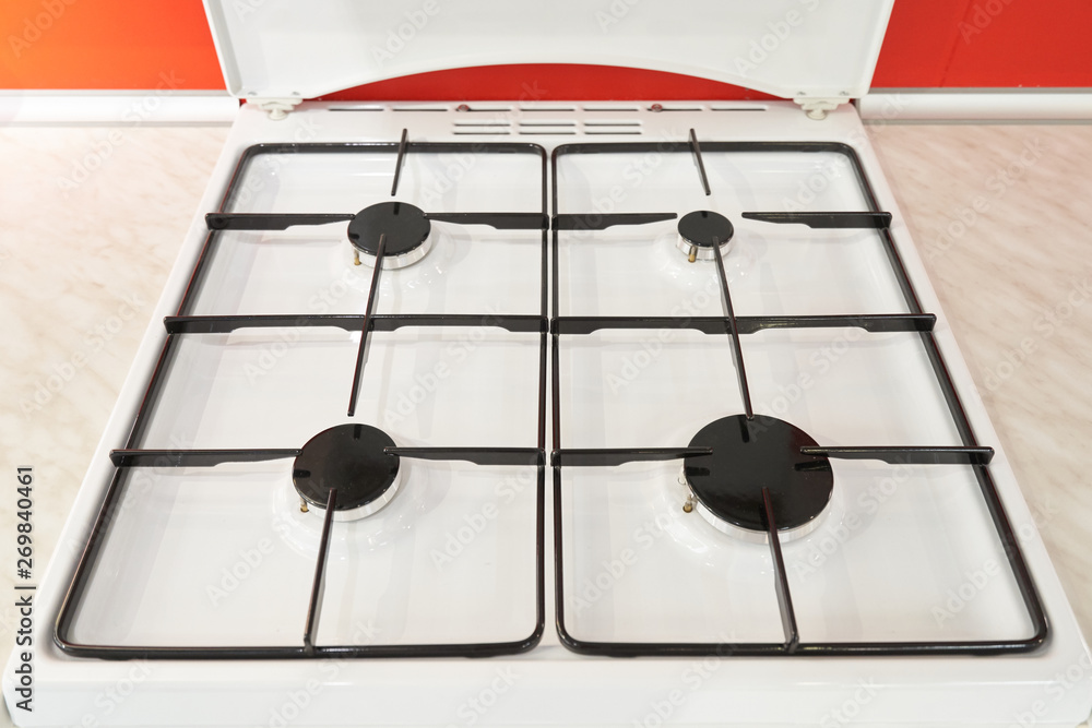 Classic white gas stove and four burners. Close-up Classic white gas stove and four burners. Close-up