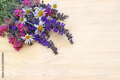 bunch of wildflowers on a wooden table