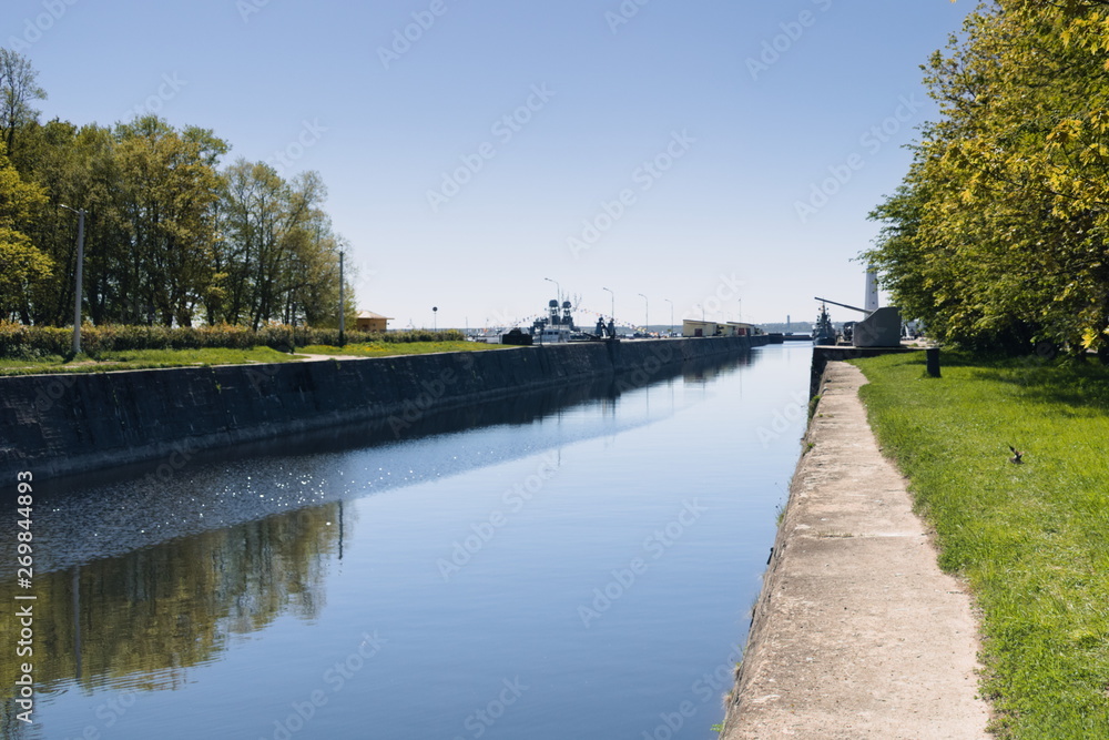 Navigable channel between the two shores. Trees are reflected in the water. Navigable channel between the two shores. Trees are reflected in the water.
