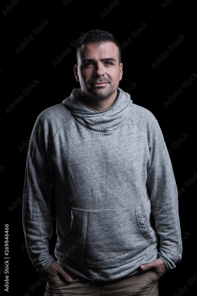Studio portrait of a serious man looking at the camera. Isolated on black background. Vertical. Studio portrait of a serious man looking at the camera. Isolated on black background. Vertical.