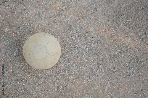 Old soccer ball on playground