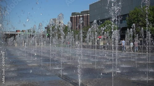 fountain in the public space in front of the museum of the city in sunny holiday, 5x slow motion