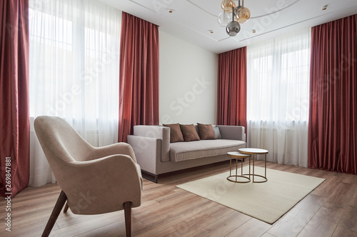 small living room with a sofa, armchair, coffee table and carpet