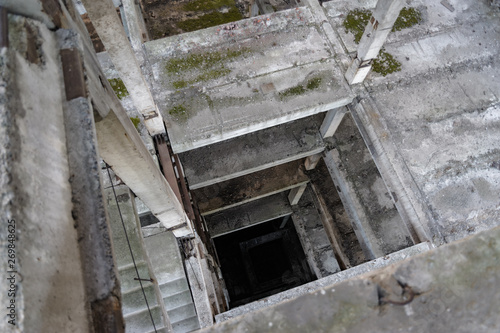 staircase in an unfinished building, abandoned, concrete floors, ruins, concrete elevator shaft