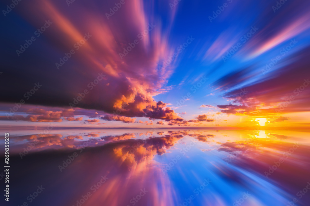 Beautiful sunset sea background. Multicolored sunset. Reflection of the setting sun in the water. Nature  background. Flying sky Clouds in motion. Sunset in a blur.