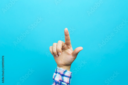 Person pointing at something on a blue background