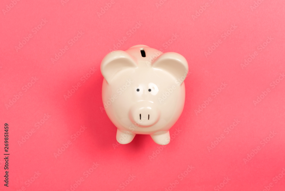A piggy bank saving and investment theme on a pink paper background