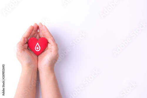 Woman hands holding red heart for blood donation,world blood donor day. Copy space for advertisers.