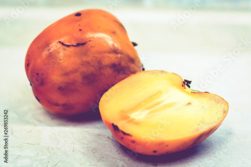 Fresh ripe persimmon on white background, vegetarian concept.