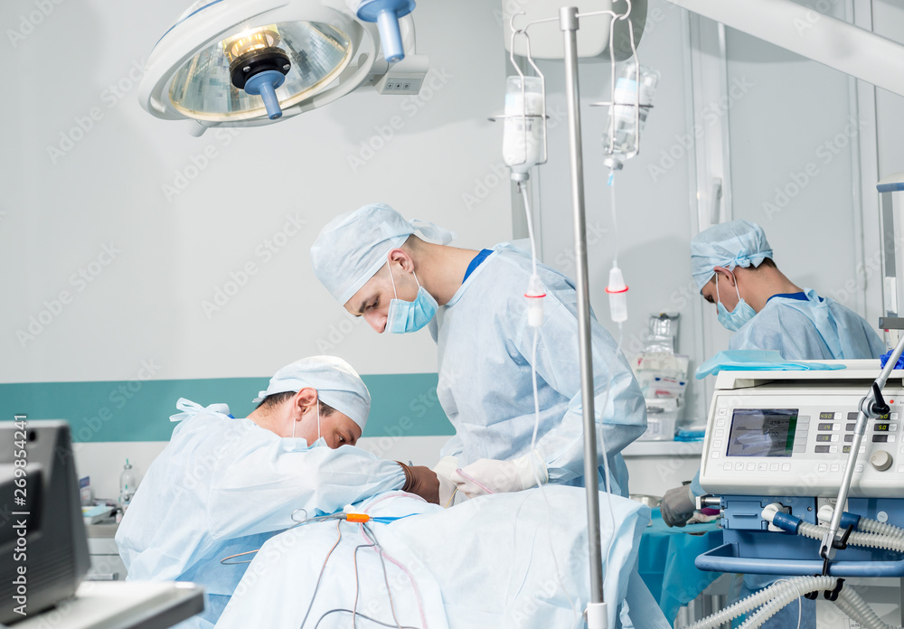 Brain surgery. Group of surgeons in operating room with surgery equipment. Brain surgery. Group of surgeons in operating room with surgery equipment.
