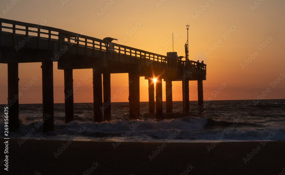 Sunrise at St. Augustine Beach Pier with silhoutted fisherman