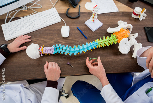 Doctor show polyaxial screw on the spine model. Spine fixation systems photo