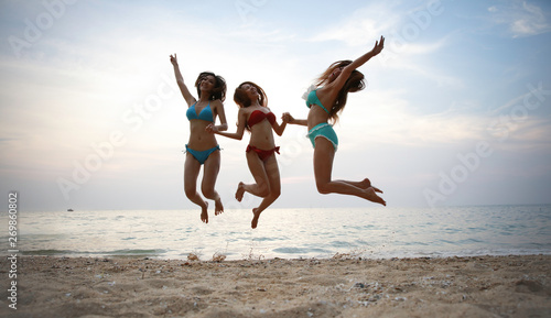 Group of woman close friend jump up on beach