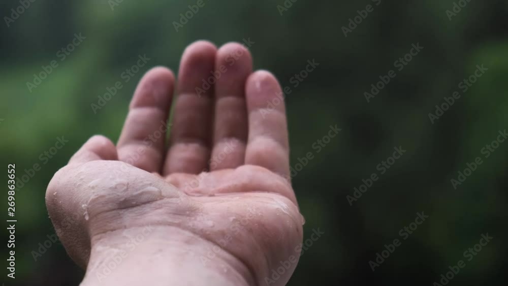 Man putting his hand in the rain Man putting his hand in the rain