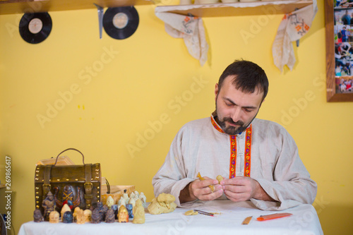 Potter making clay figure for board game photo