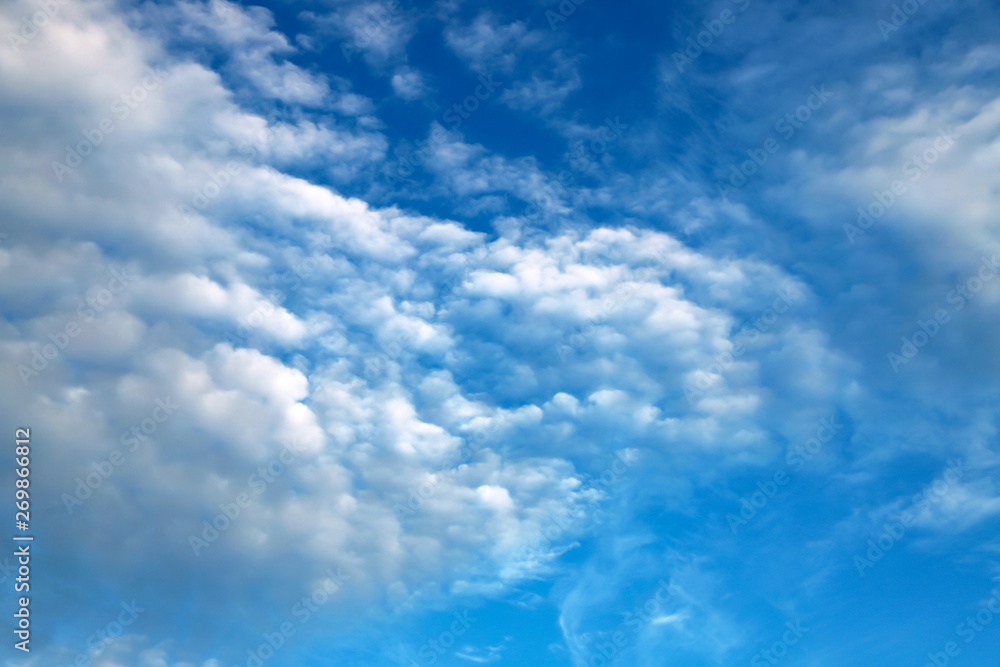 Obraz premium Beautiful white clouds, cumulonimbus, cumulus, rain clouds against a blue sky. Picturesque, fantastic white clouds, landscape background for summer, spring poster.