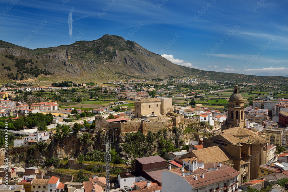Fertile genil river valley at Loja Spain with Church of the Incarnation and Moorish Alcazaba fortress under Gorda Peak