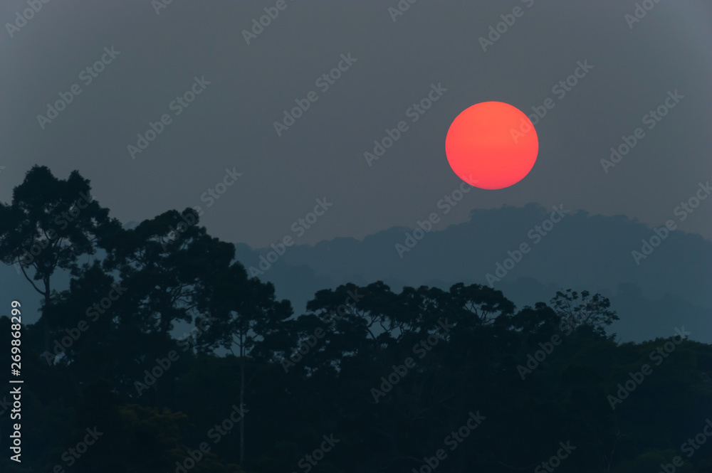 The sun setting above a mountain range.