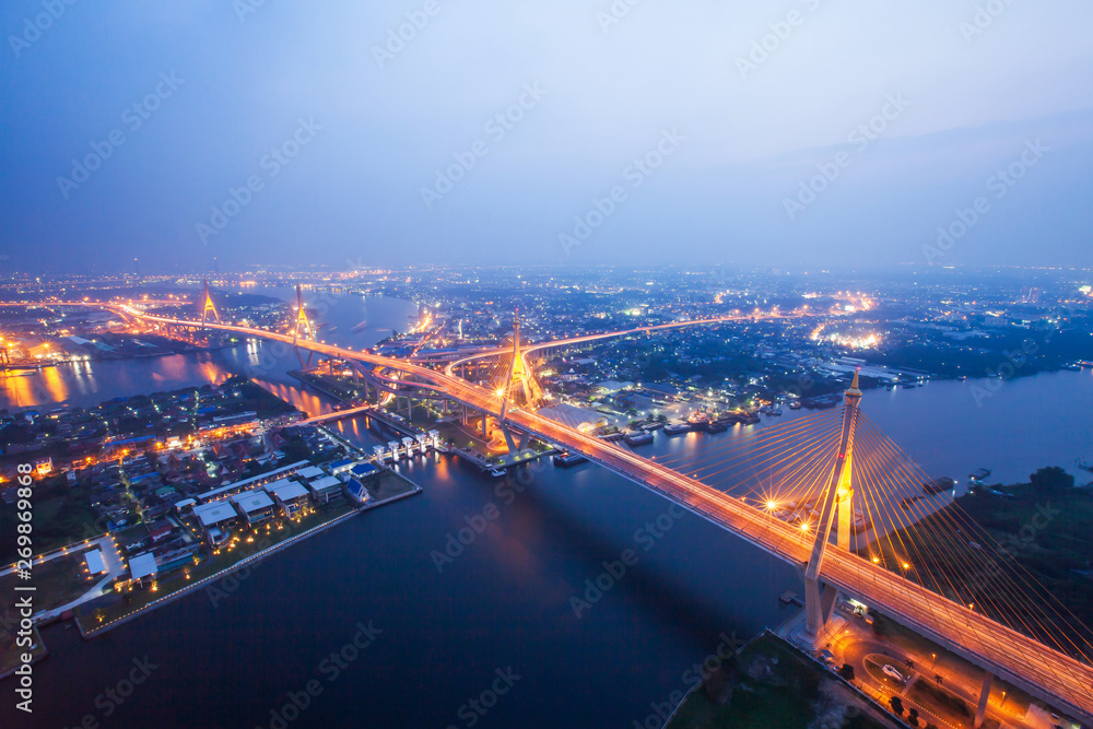 Fototapeta premium Aerial view of Bhumibol Suspension Bridges and highways interchange at twilight.