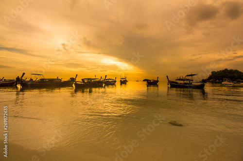 beautiful sunrise or sunset on the sea with boat in Koh Lipe, Satun province,Thailand.