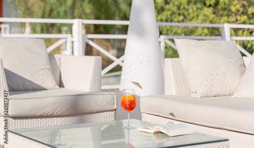 Aperol spritz cocktail and open book on a table. Relax concept, summertime