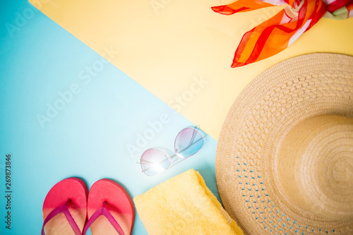 Beach accessories on yellow blue background