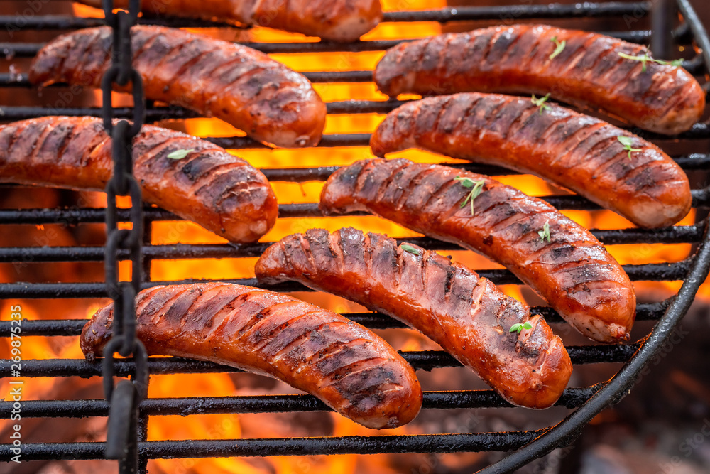 Fototapeta premium Top view of sausage on grill with spices in summer