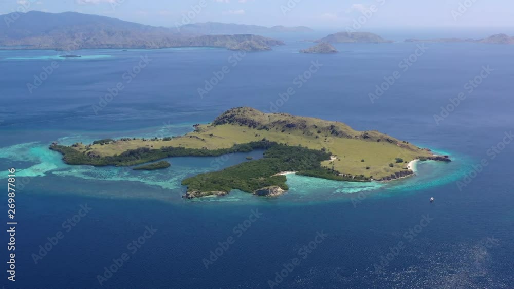 The beautiful island of Tatawa is surrounded by a mangrove and reef in Komodo National Park, Indonesia. This tropical area is known for both its marine biodiversity as well as its infamous dragons. The beautiful island of Tatawa is surrounded by a mangrove and reef in Komodo National Park, Indonesia. This tropical area is known for both its marine biodiversity as well as its infamous dragons.