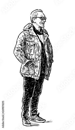 A casual townsman standing and smiling on the street