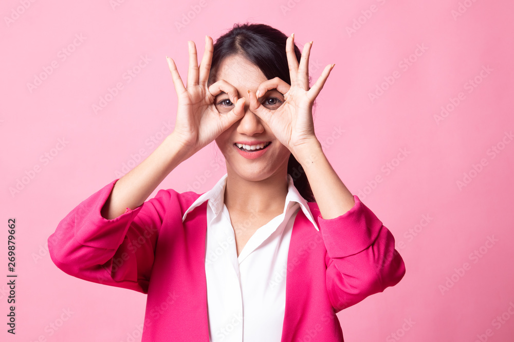 Asian woman do funny double OK sign as glasses. Asian woman do funny double OK sign as glasses.