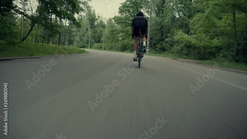 Wallpaper Mural Cyclist Cycling On Road Bicycle Before Triathlon.Bicycle Wheel Close Up.Triathlete Twists Pedals On Bike.Gear System Road Bicycle.Athlete Cyclist Riding On Carbon Bicycle.Cyclists Riding At Sunset.	 Torontodigital.ca