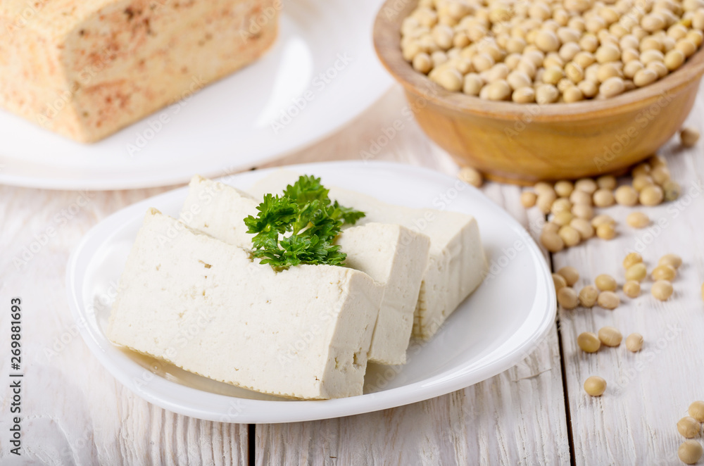 Soy Bean curd tofu on clay dish closeup. Non-dairy alternative substitute for cheese