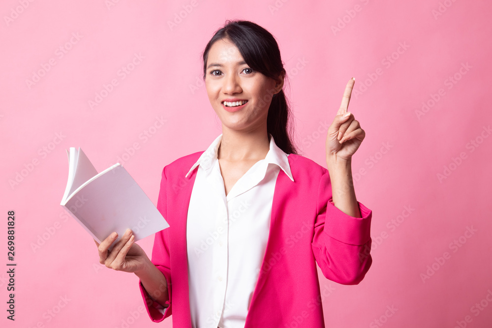 Young Asian woman with a book have an idea. Young Asian woman with a book have an idea.