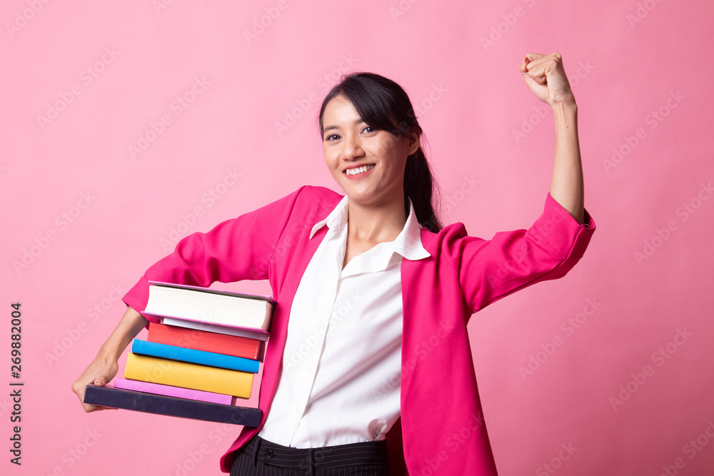 Young Asian woman studying with may books. Young Asian woman studying with may books.